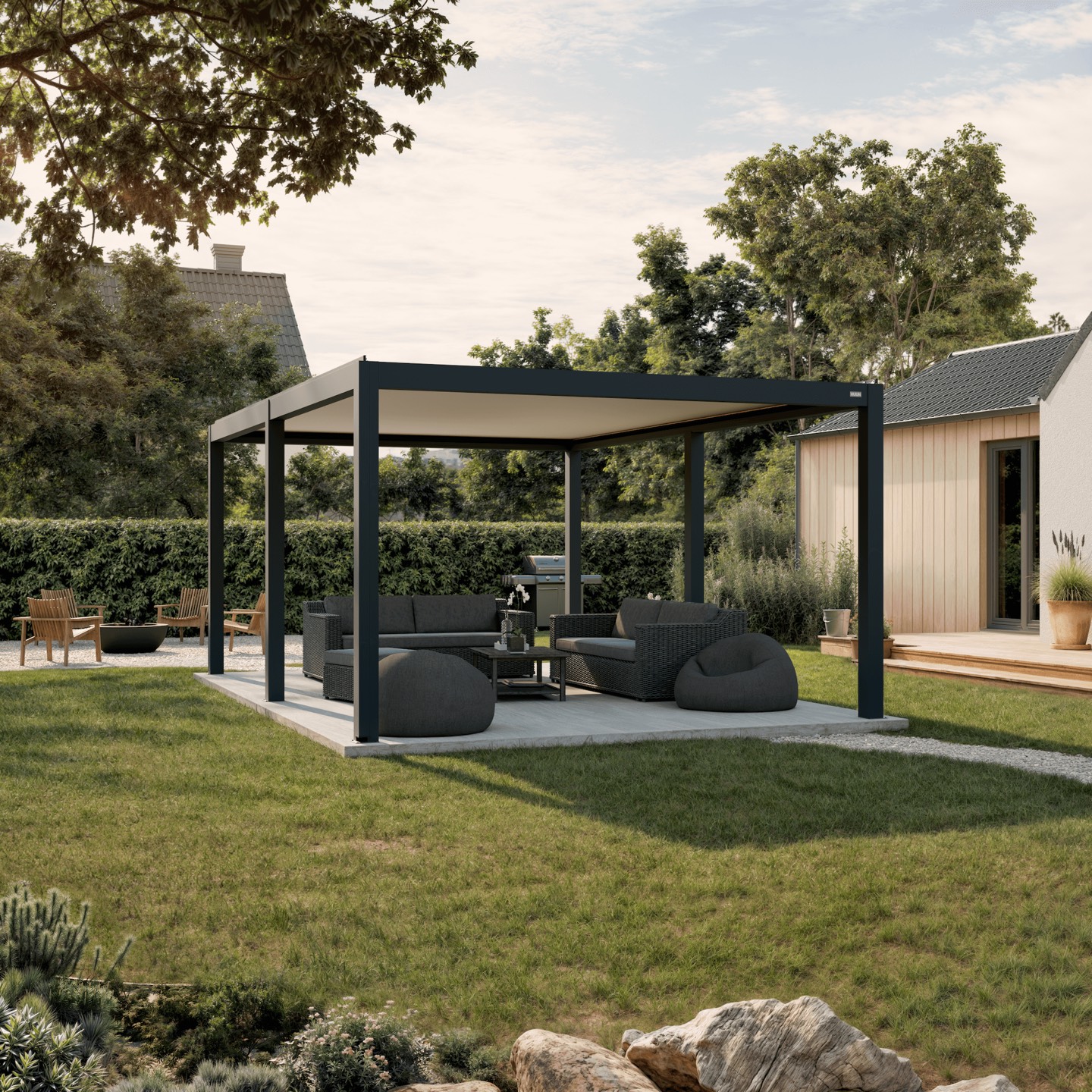 Anthracite Pergola Mezzo freestanding louvered pergola over an outdoor lounge in a hedged garden