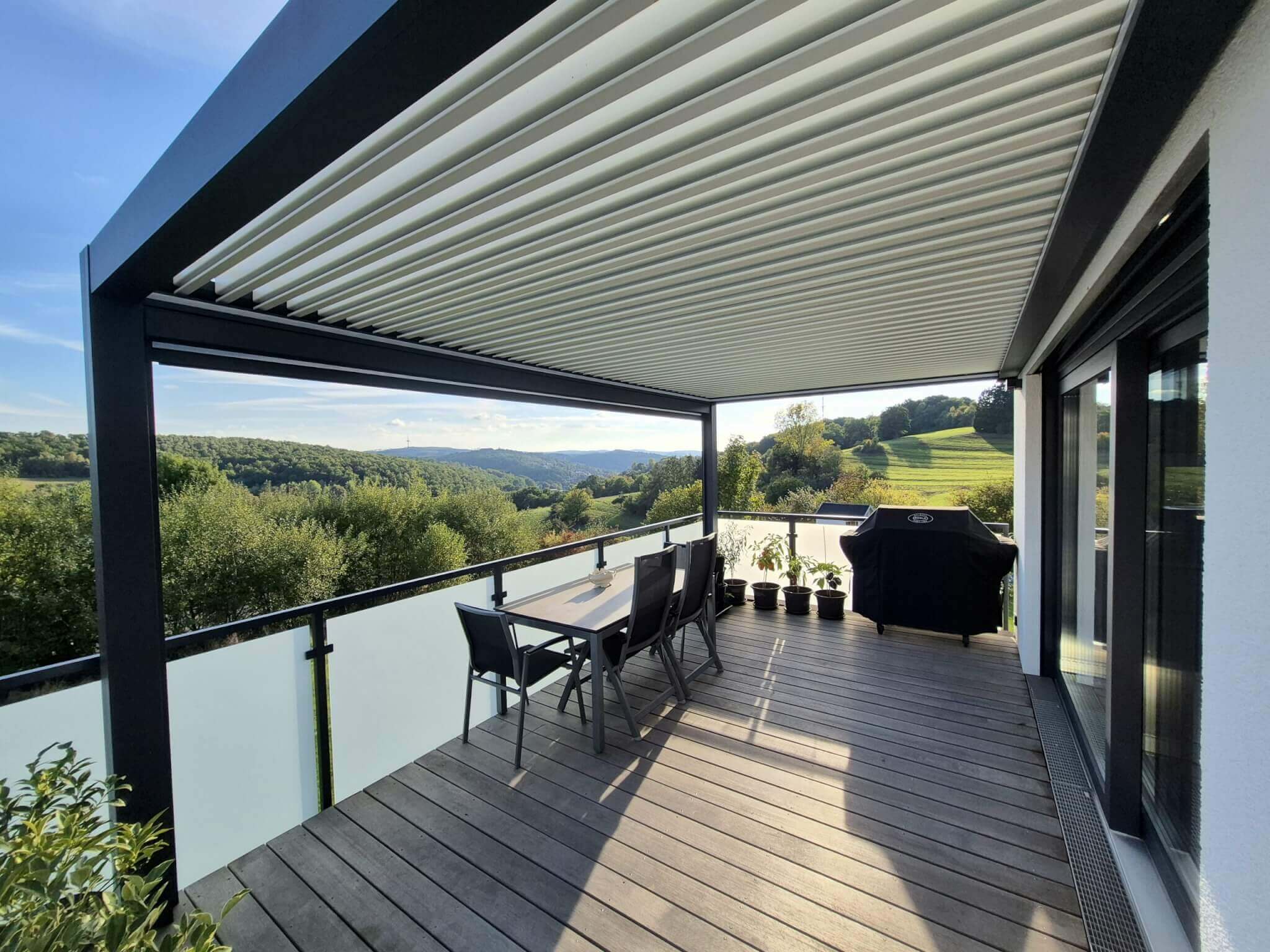 An Ombra louvered pergola shading a terrace
